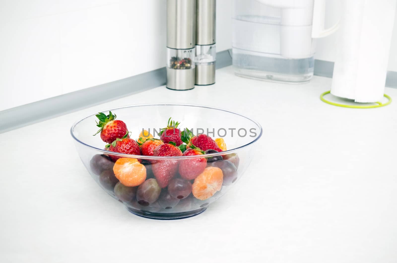 Glass bowl full of fruit in a modern kitchen by simpson33