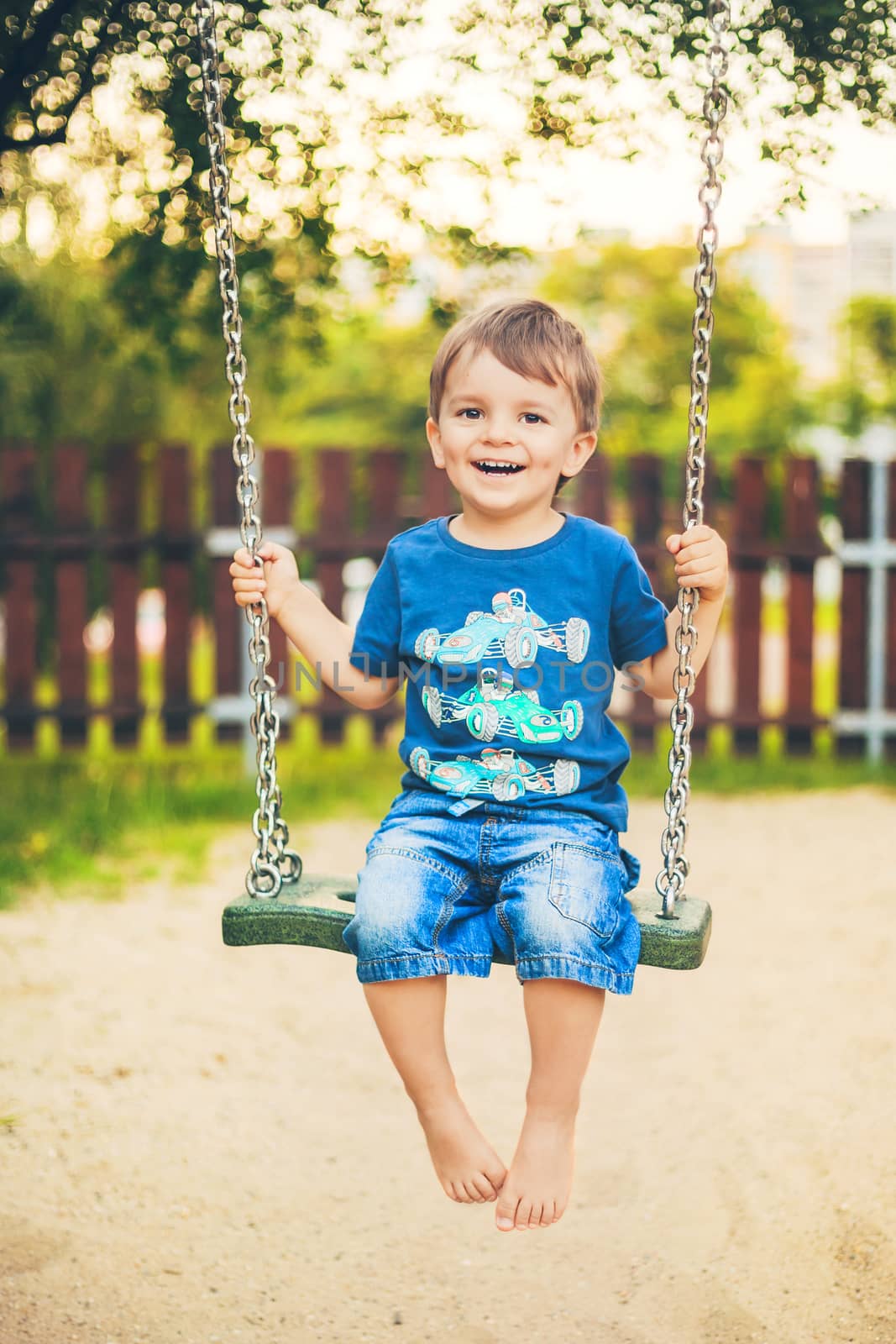 smiling boy on a swing by zhu_zhu