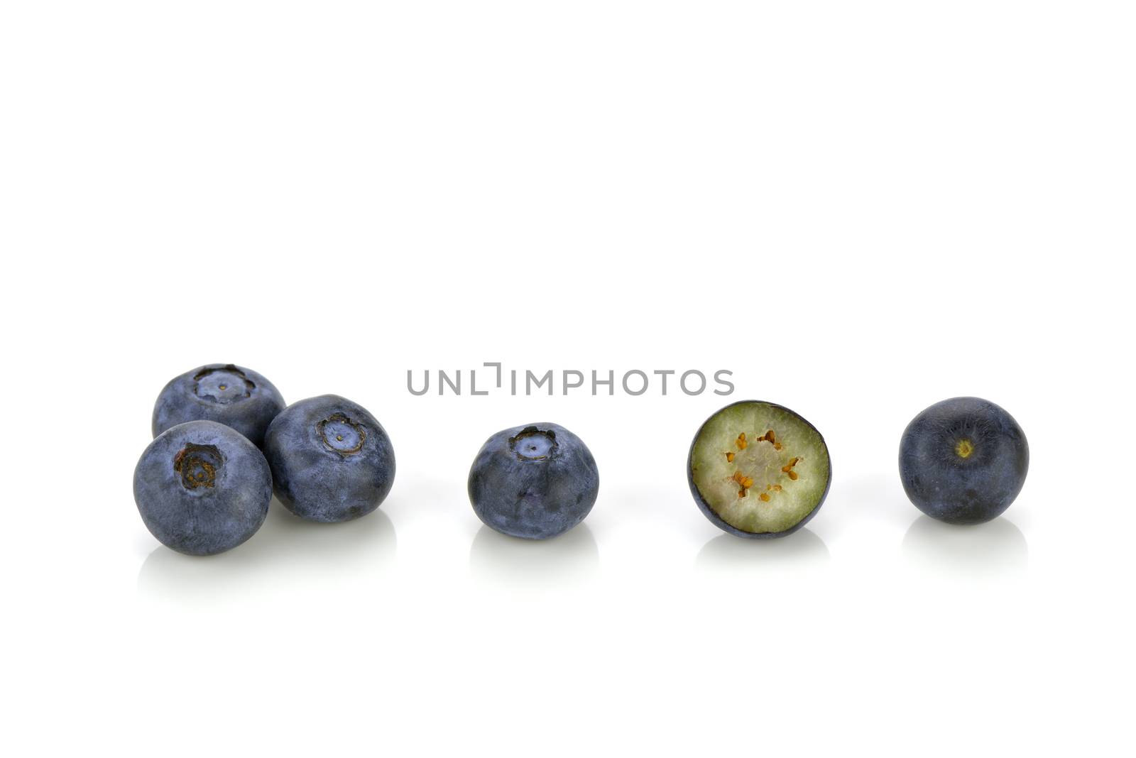 Close-up of several blueberries, one is cut in half