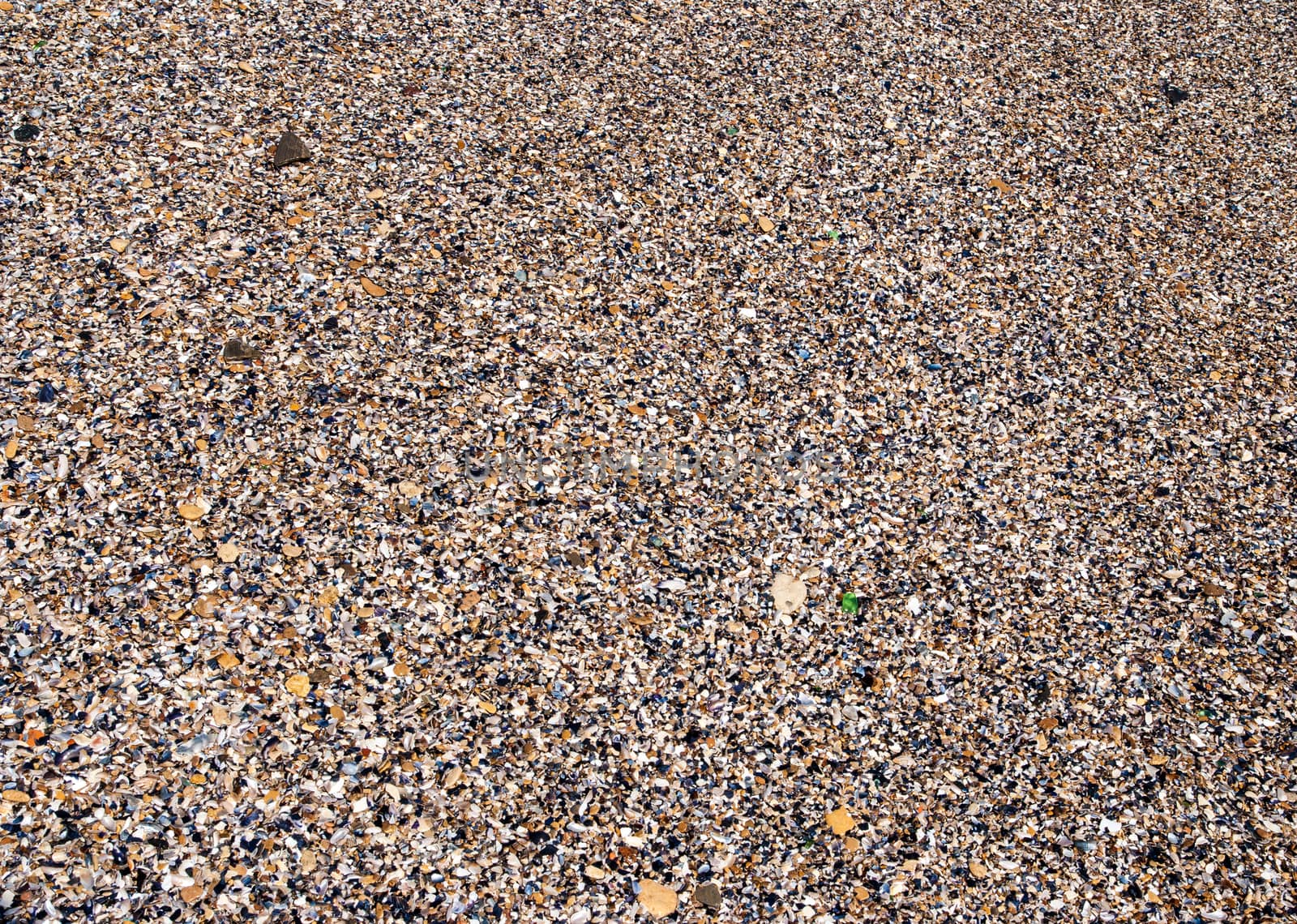 Sea sand, pebbles and seashells, background texture