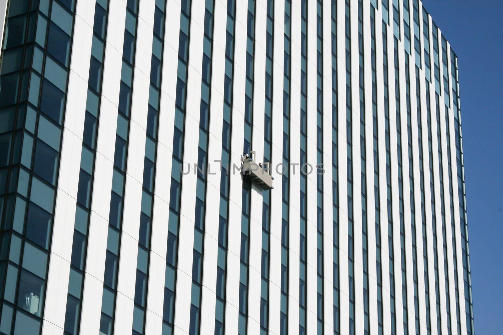 Gondola with window two cleaners on skyscraper