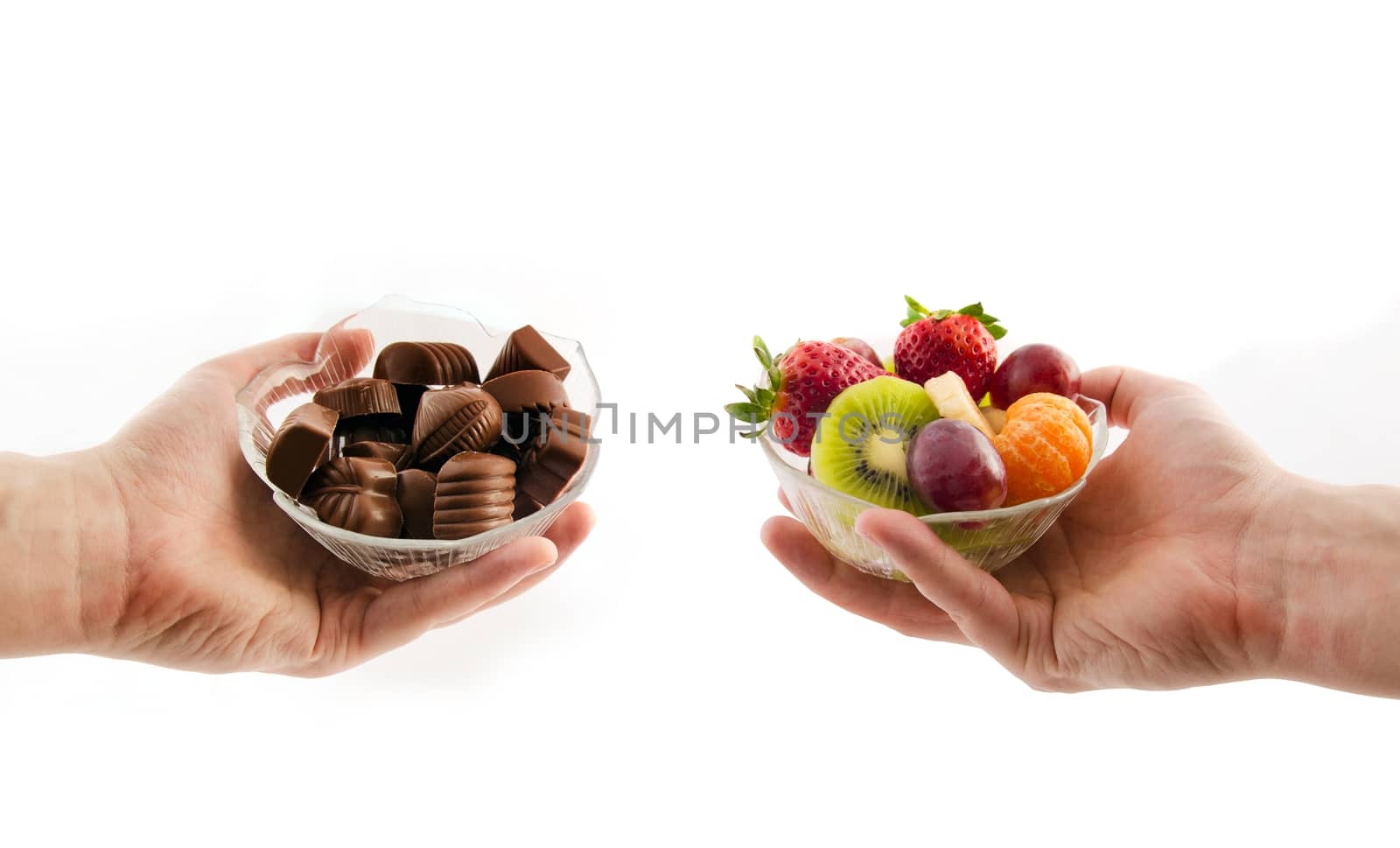 Choose healthy foods. Bowl with chocolates and a bowl of fruit