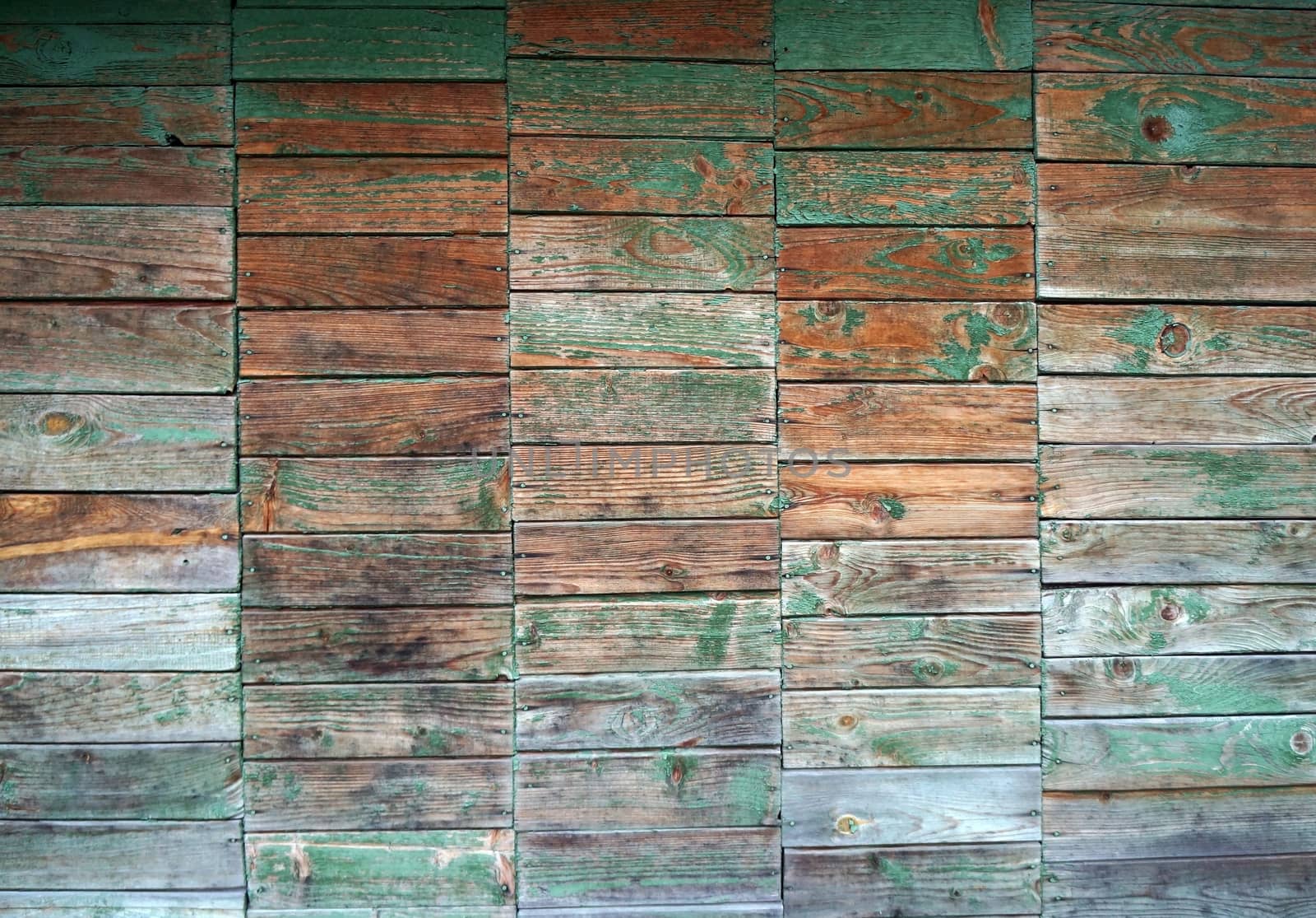 Texture of wall made of planks with paint peeling off
