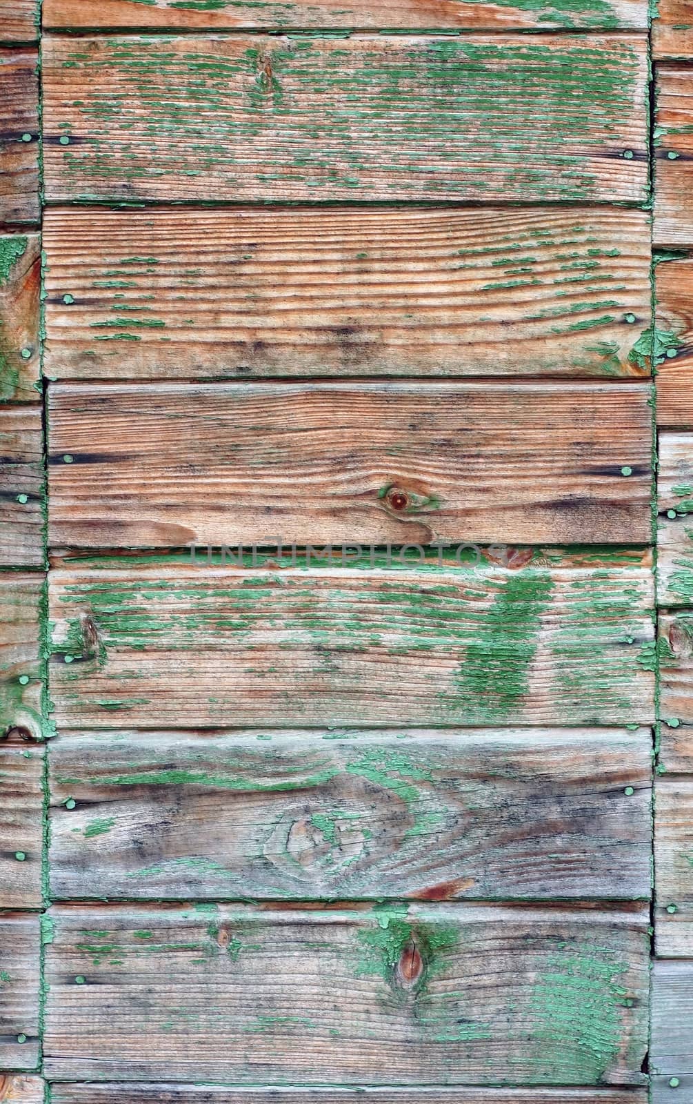 Texture of wall made of planks with paint peeling off