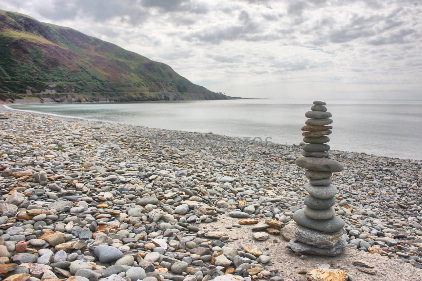 stones balancing on top of each to make a tower on a beach