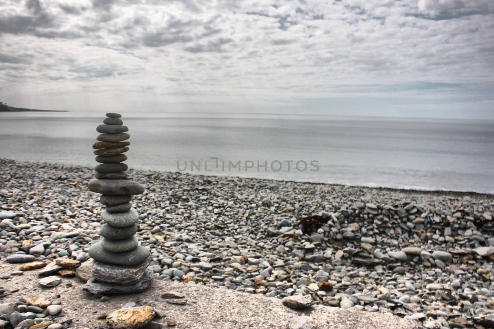 stones balancing on top of each to make a tower on a beach by chrisga