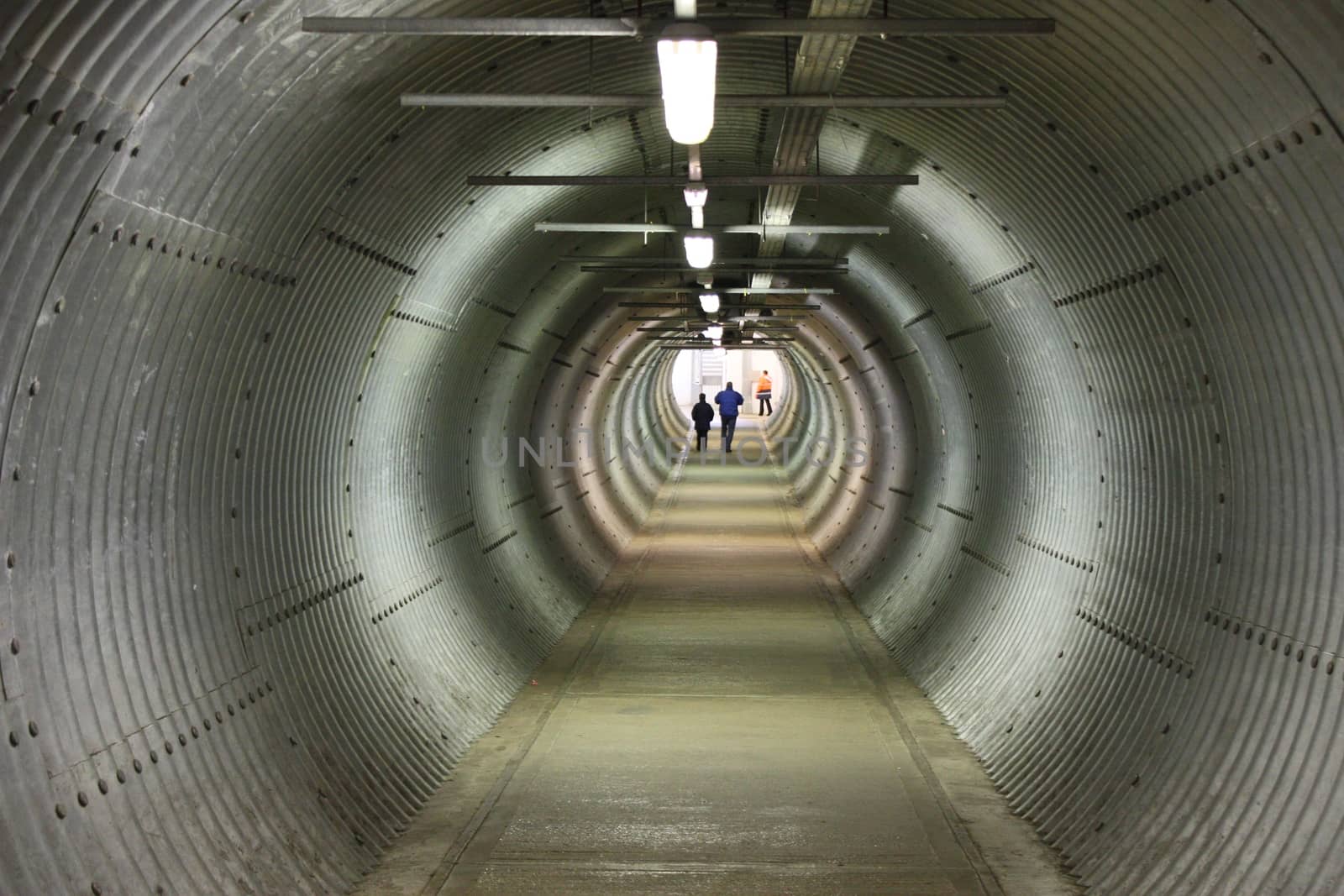 long circular pedestiran tunnel sheeted in corrugated metal