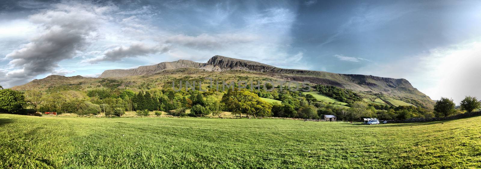 Stunning welsh mountains under a cloudy blue sky by chrisga