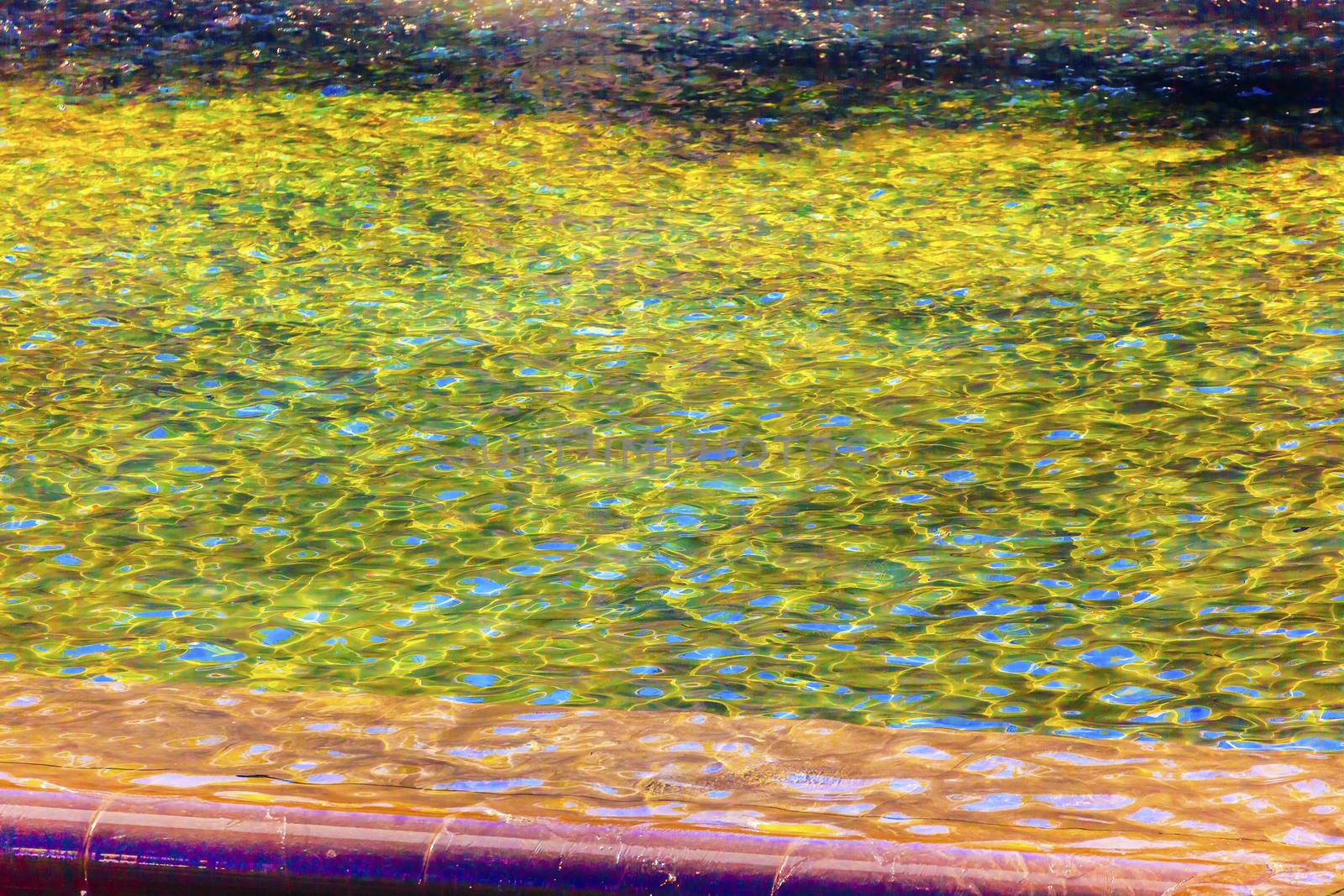 911 Memorial Pool Blue Yellow Green Reflections Pattenrs Abstract New York NY.  Pool is in the foundation of one of the Two World Trade Center Buildings.  Water falls into hole of the foundation.  