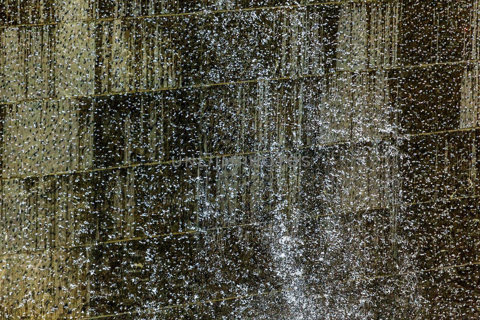 911 Memorial Pool Blue Waterfall Droplets Patterns Abstract New York NY.  Pool is in the foundation of one of the Two World Trade Center Buildings.  Water falls into hole of the foundation.  