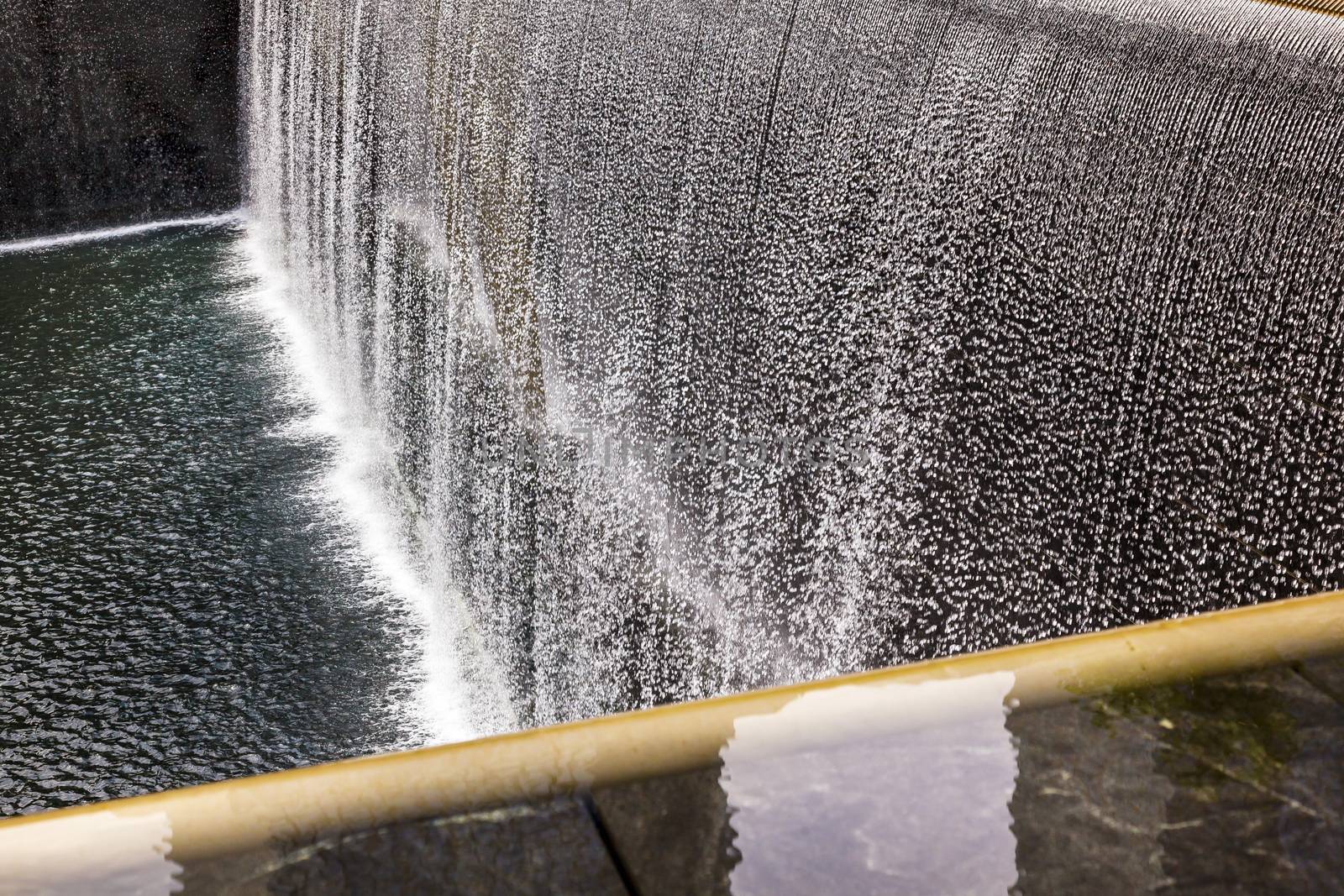 911 Memorial Pool Fountain Waterfall Reflections Abstract New York NY.  Pool is in the foundation of one of the Two World Trade Center Buildings.  Water falls into hole of the foundation.  