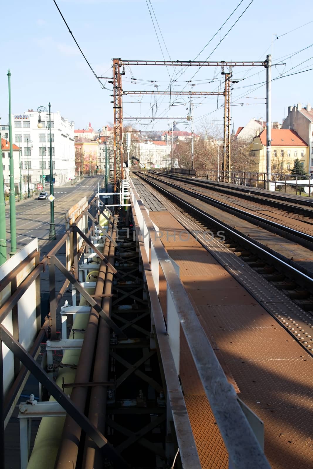 Photo shows details of old train tracks and houses.