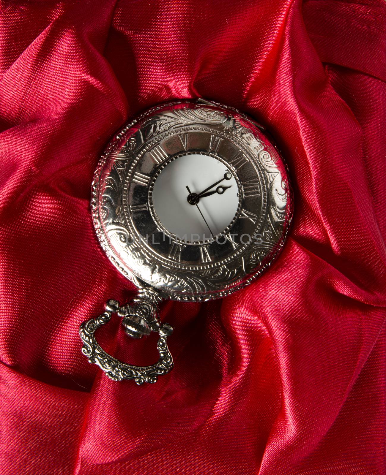 Pocket gray clock on red silk texture