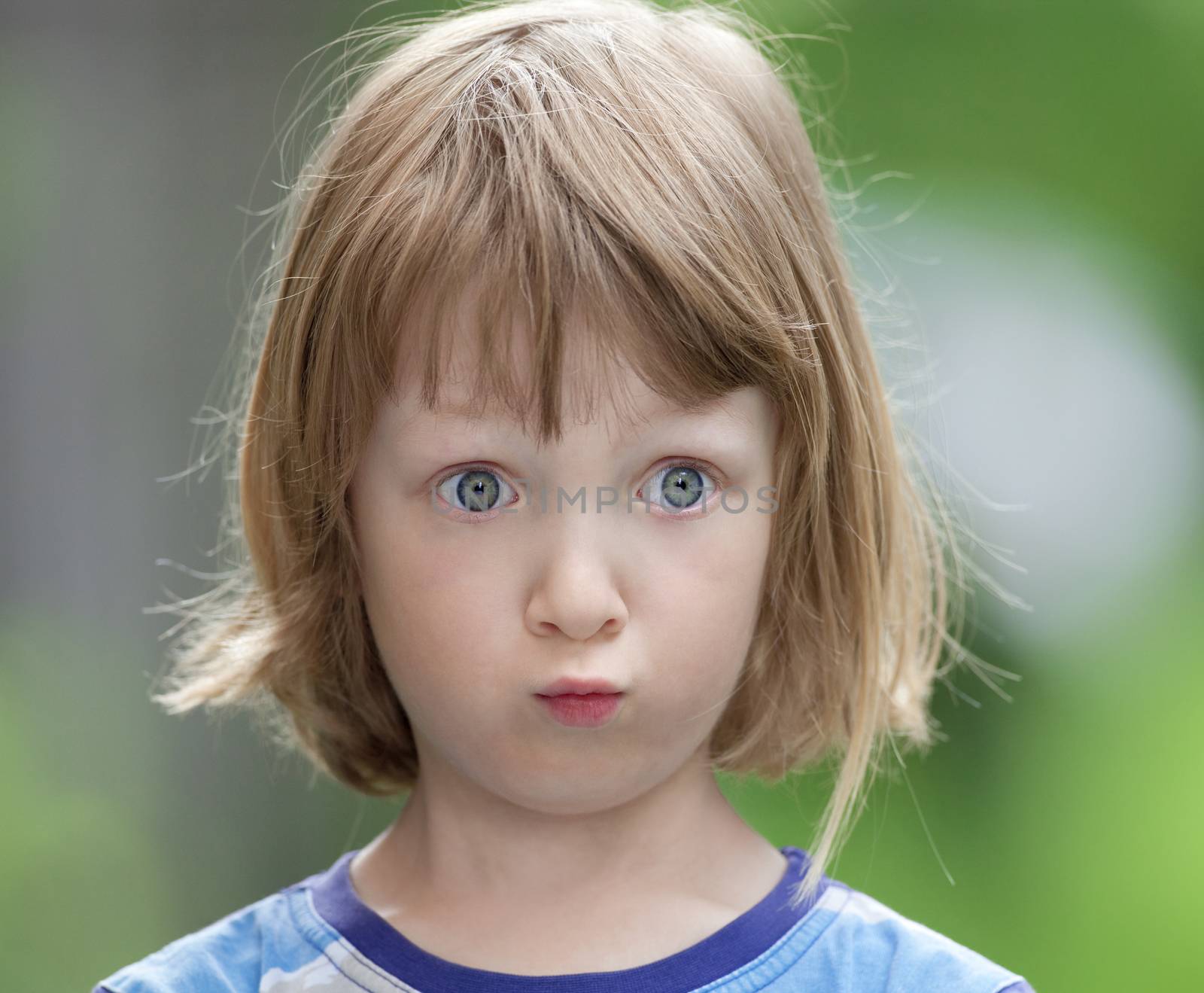 Portrait of a Boy with Long Blond Hair Looking