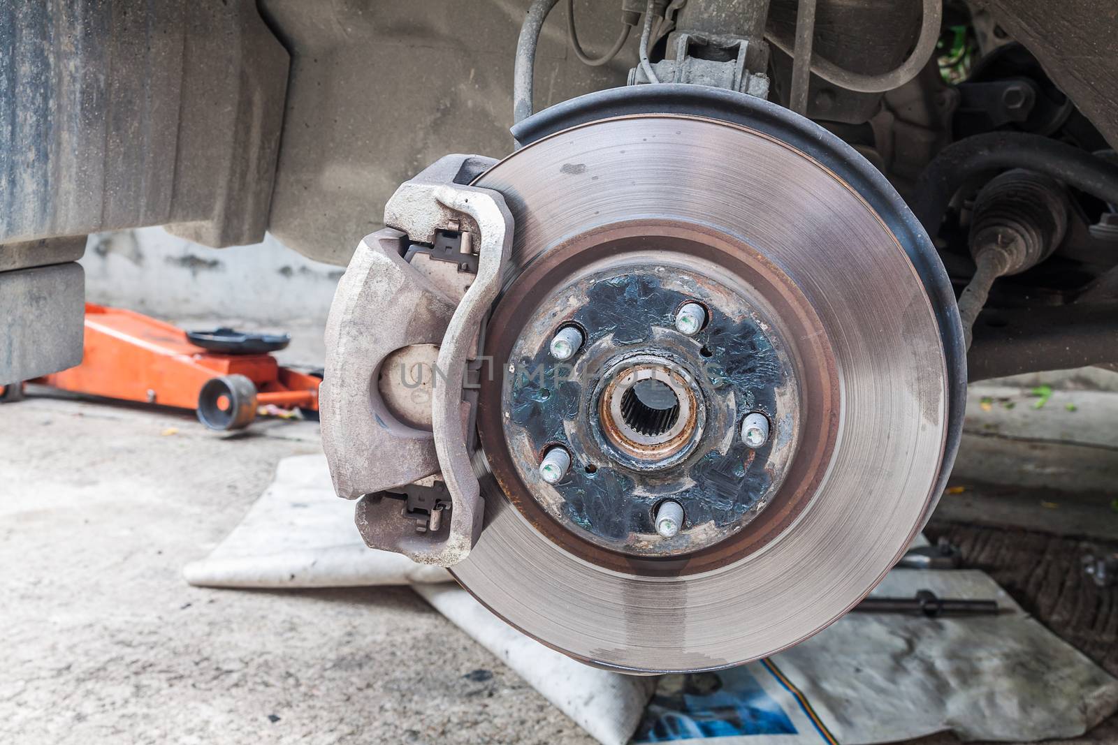Closeup photo of car disc brakes fixing outdoor