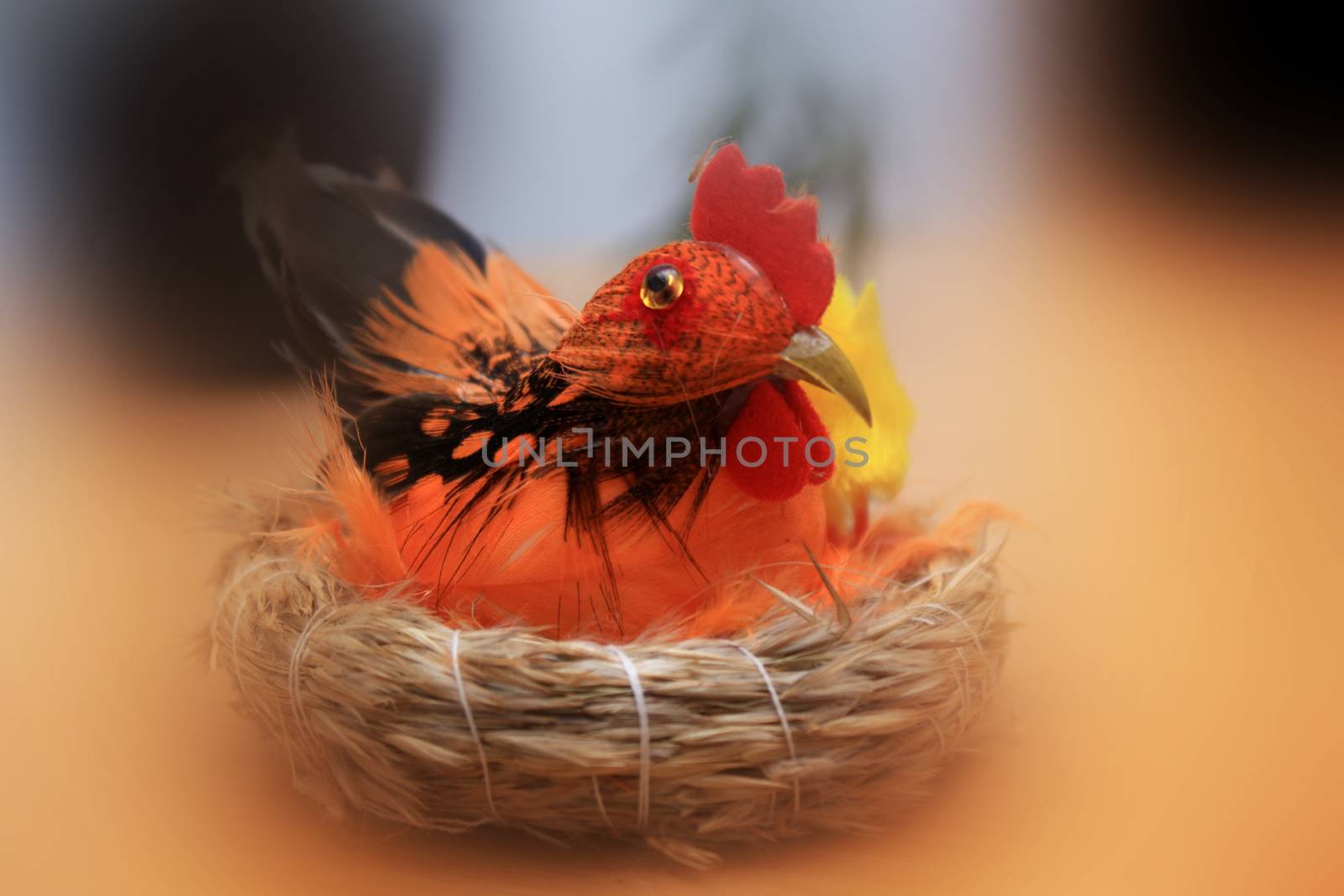color rooster in a joyful Easter basket with colored background 