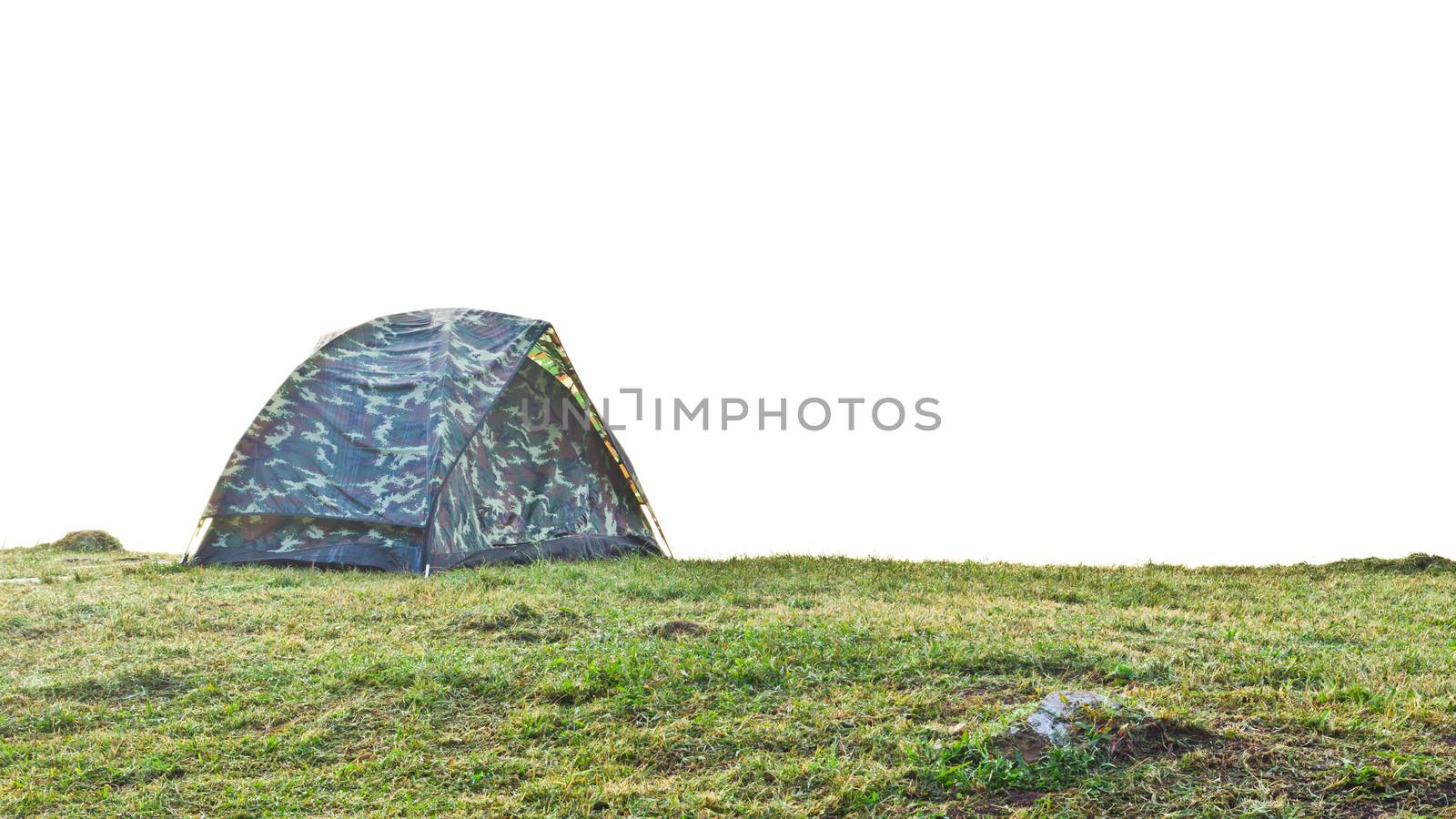 Tent camping with camouflage pattern at grass on the hill in morning