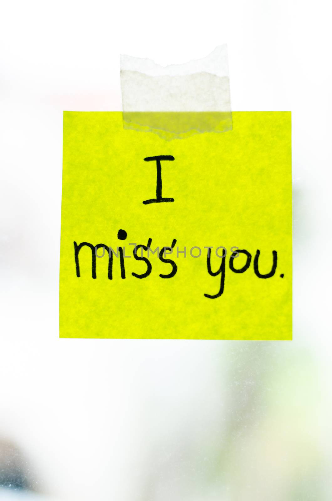 I miss you word sticky note on window mirror