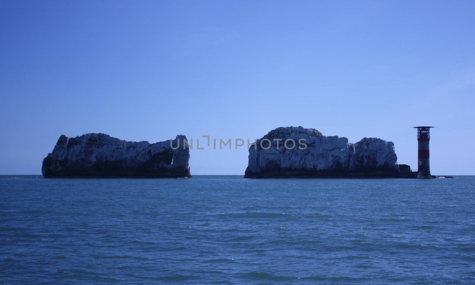 The red and white striped lighthouse at the needles in the solen by chrisga