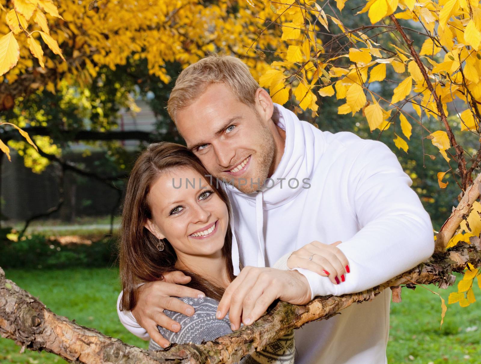 portrait of a happy young couple in the park, smiling.