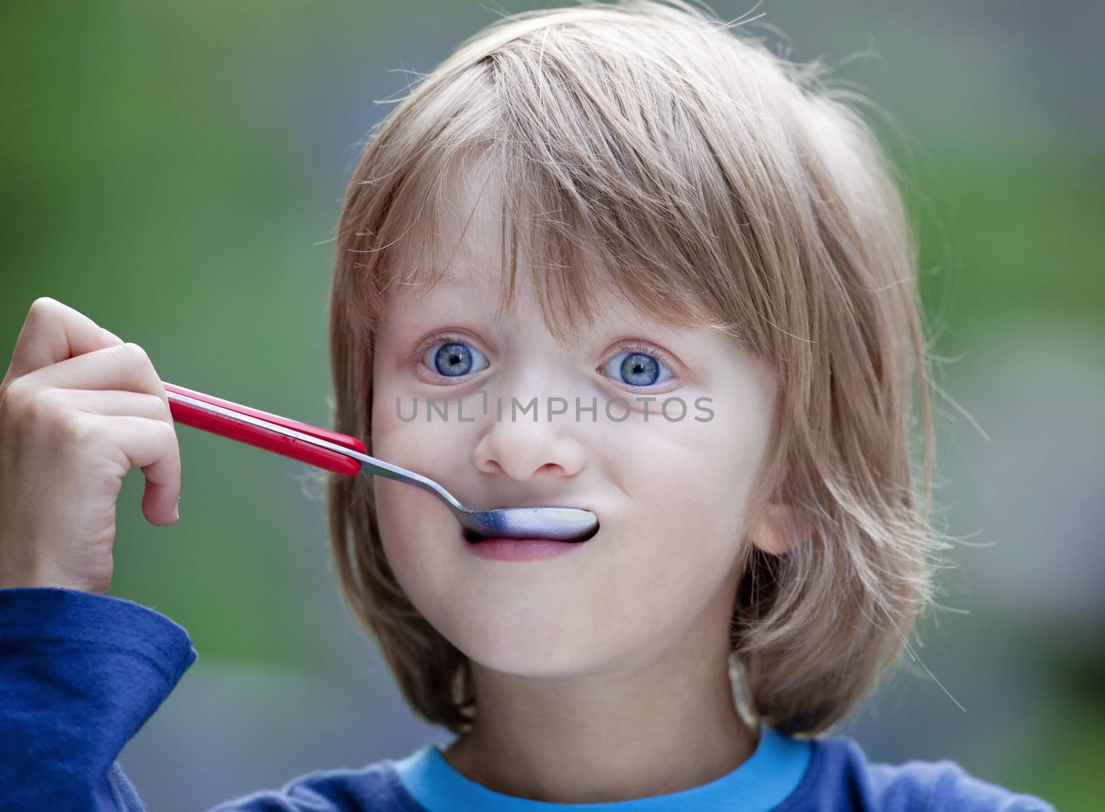 Boy with Blond Hair Eating Soup