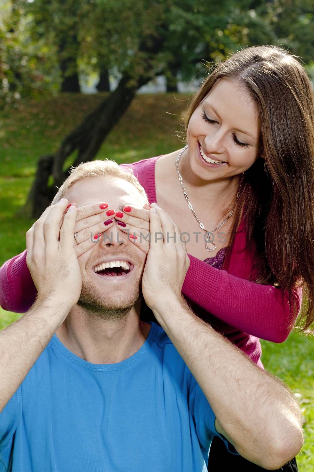 Young Girl Covering her Boyfriends Eyes to Surprise him