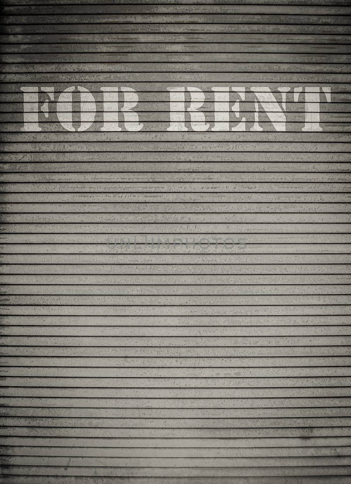 For Rent Sign On Dirty Scratched Store Roller Shutters