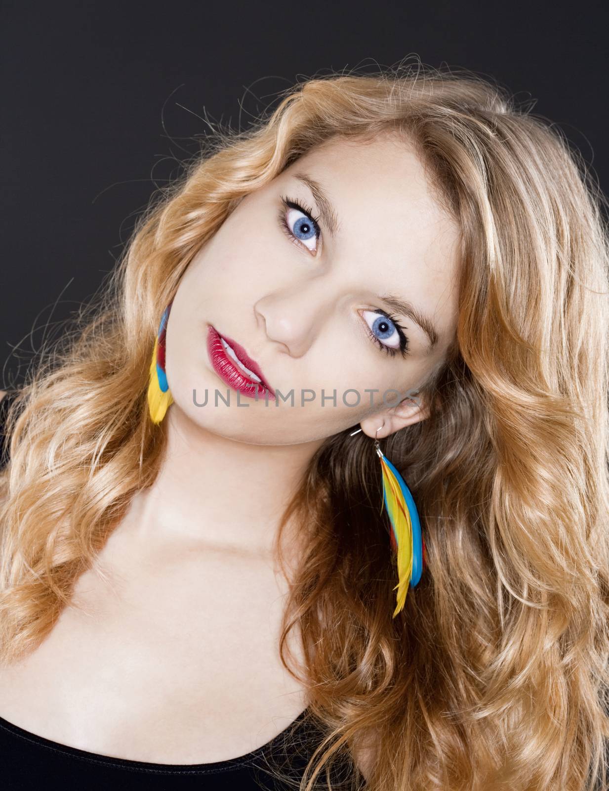 portrait of a beautiful teenage girl with blond hair - isolated on black