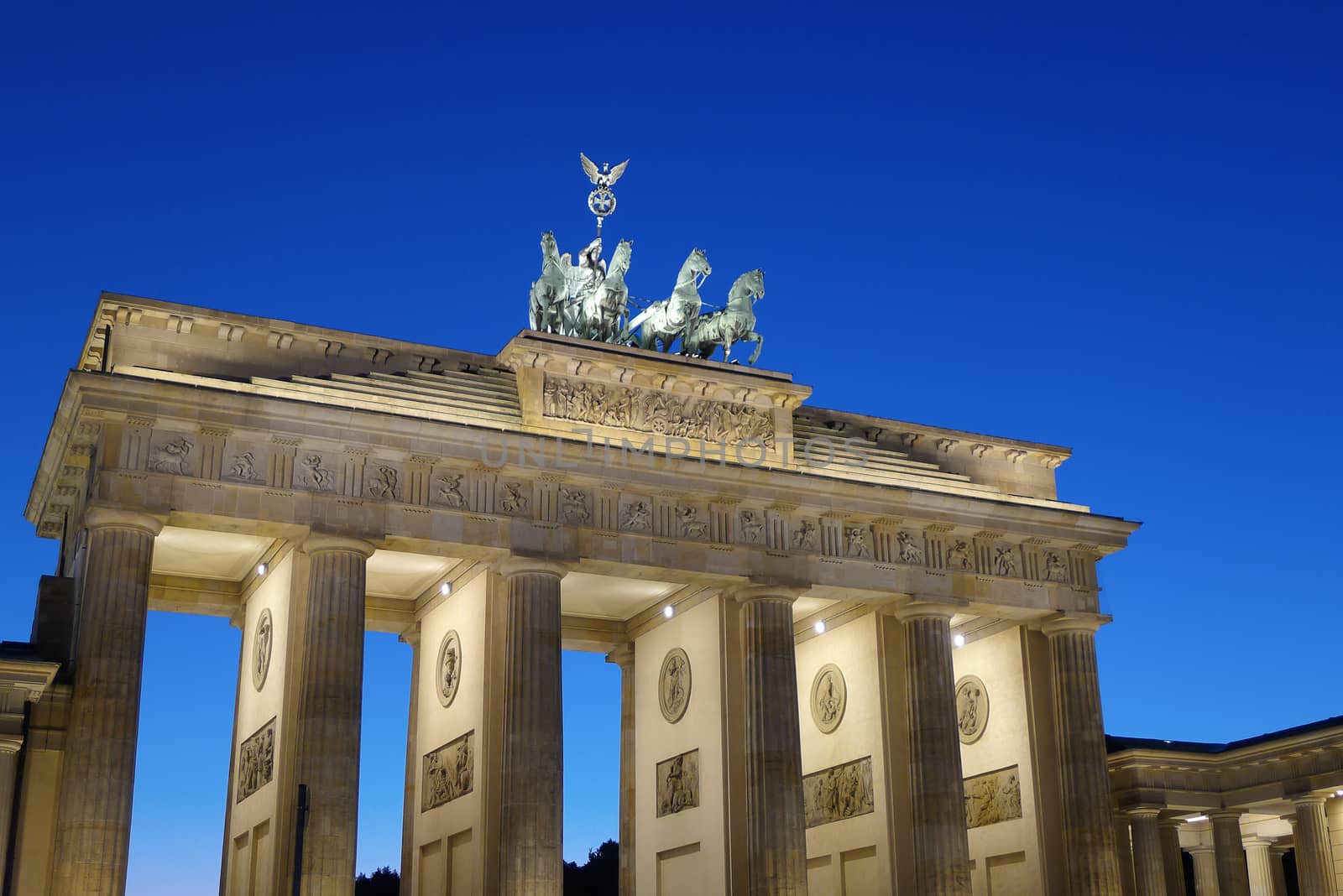 Frontal view of Brandenburg Gate at dusk in a beautiful summer day, Berlin, Germany, Europe.