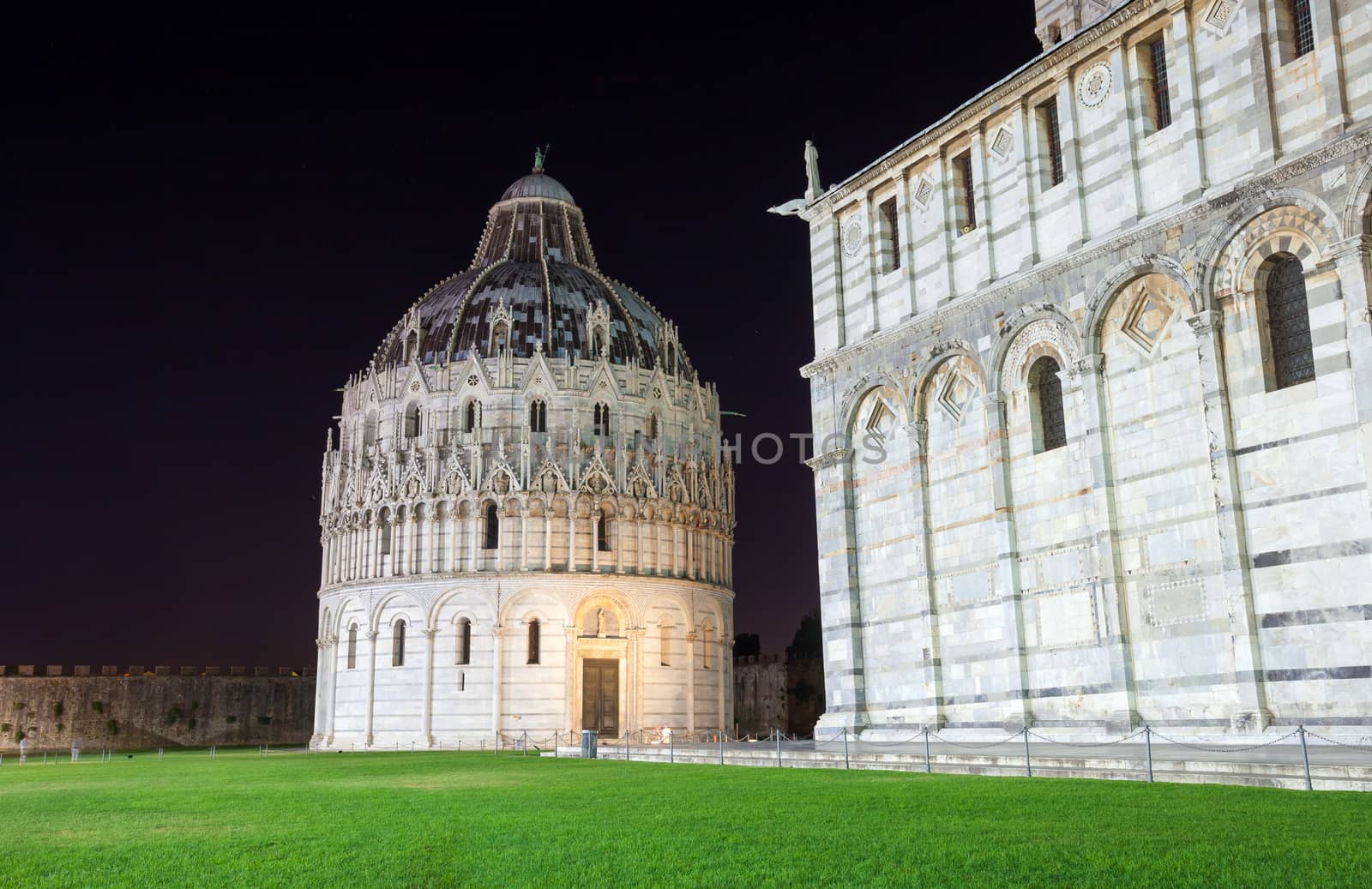 Pisa, Italy - August 11, 2013: Pisa, Piazza del Duomo with Battistero, Basilica and the leaning tower, Italy