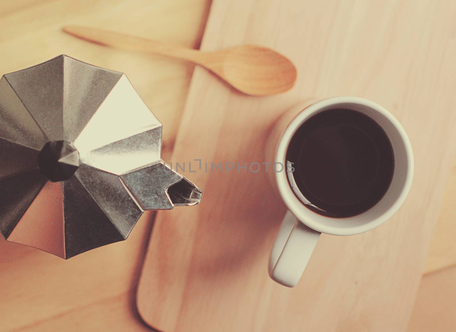 Hot coffee and moka pot with wooden spoon, retro filter effect by nuchylee