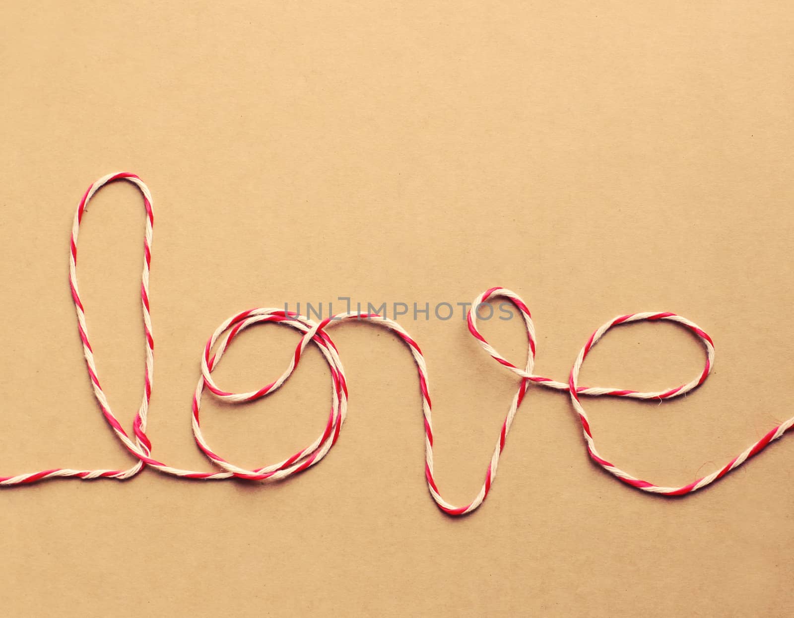 The word "love" written with rope, retro filter effect by nuchylee