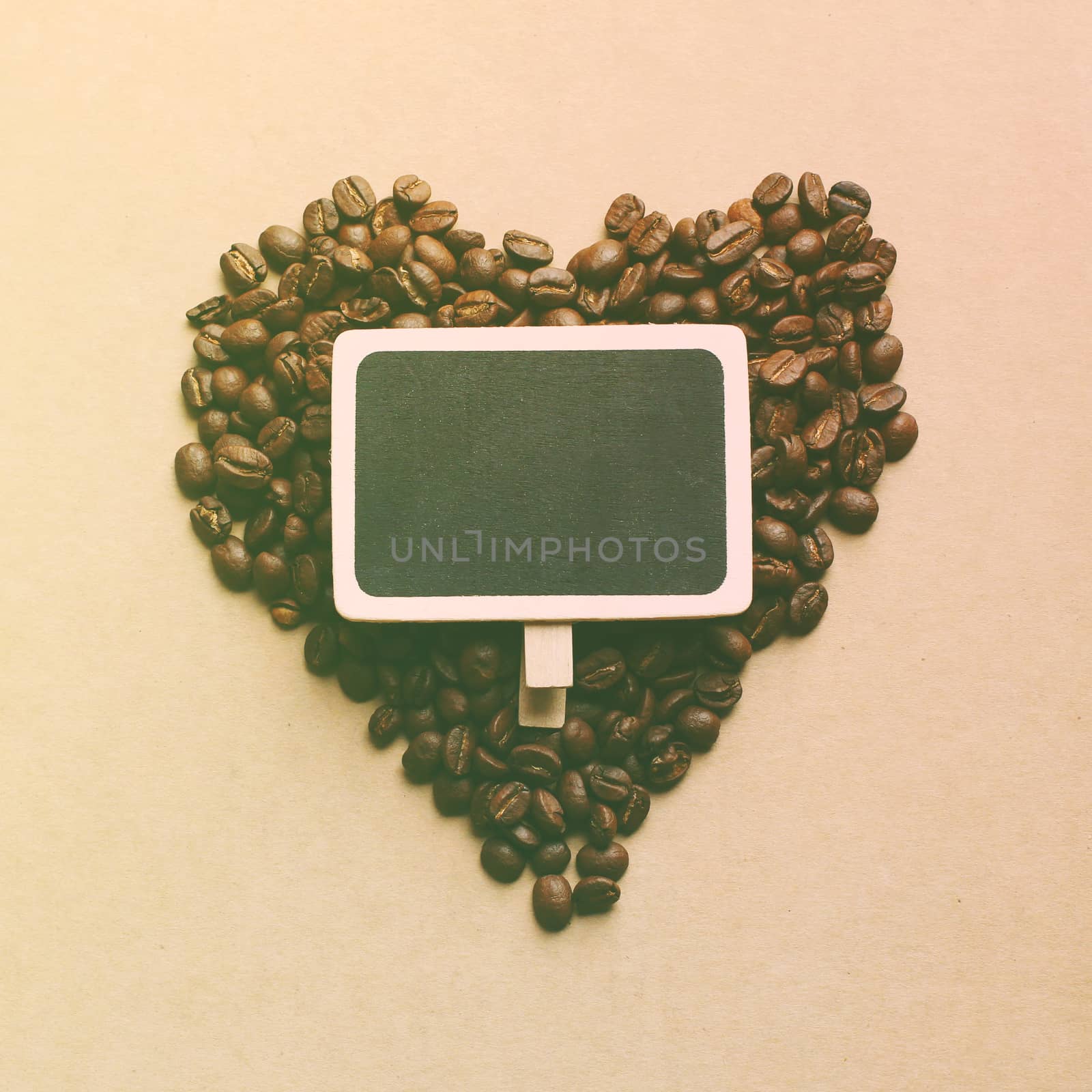 Heart shape from coffee beans with blank blackboard, retro filte by nuchylee