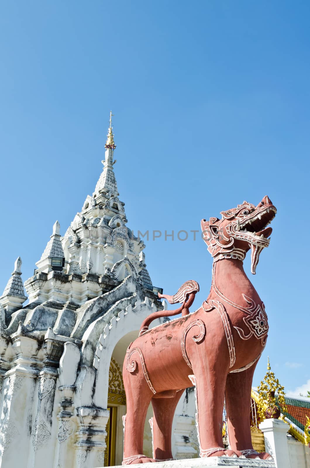 Red Lion statue at front Wat Phra That Hariphunchai temple in Lamphun Province of Thailand