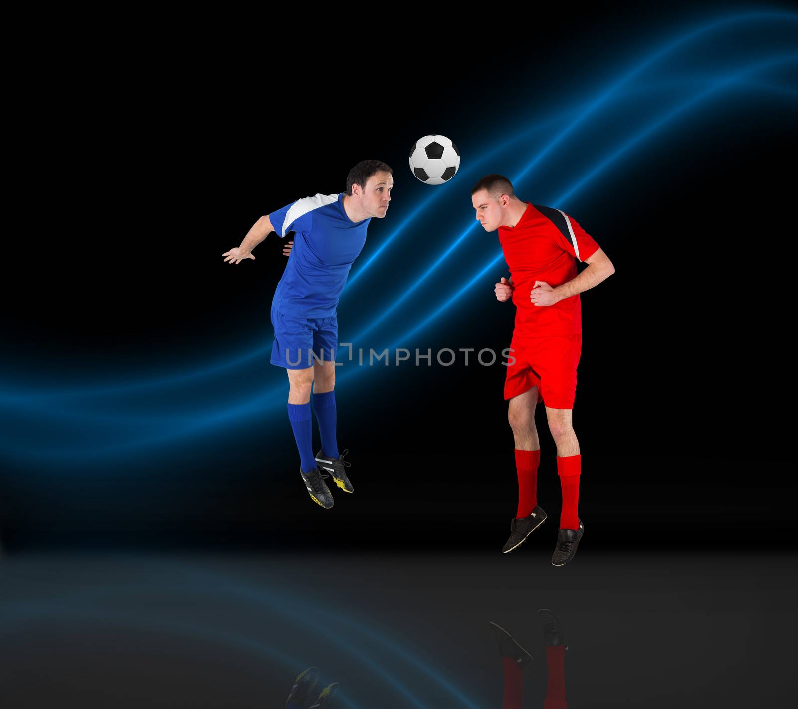 Composite image of football players tackling for the ball by Wavebreakmedia