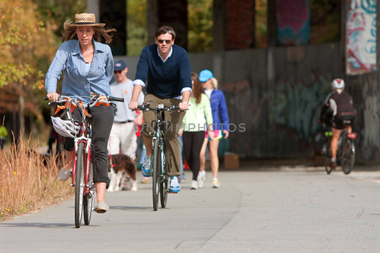 Couple Rides Bikes Along Urban Development Trail In Atlanta by BluIz60