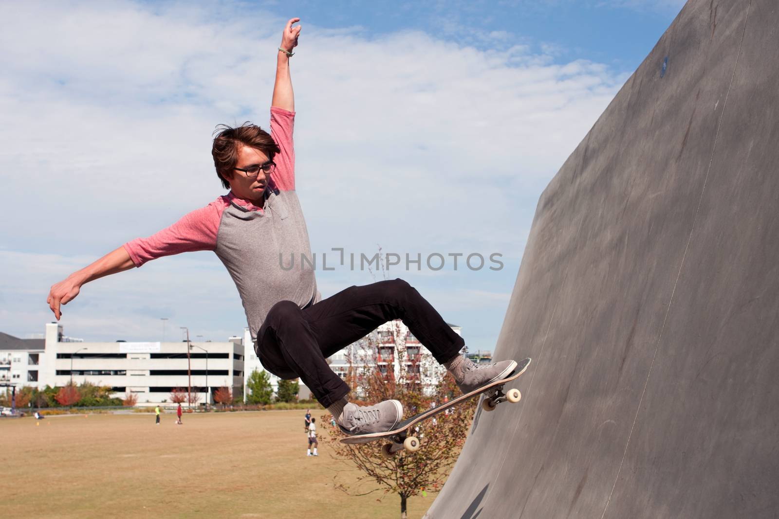 Atlanta, GA, USA - November 2, 2013:  A young adult male catches air while practicing skateboarding off a ramp at the Old Fourth Ward Skatepark near the Atlanta Beltline.
