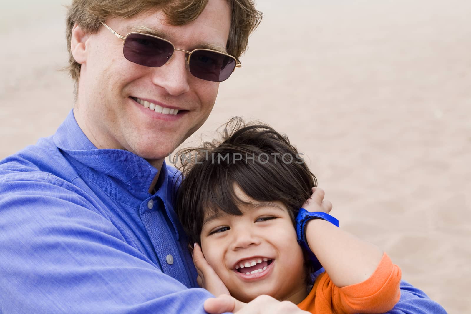 Father and son laughing together by jarenwicklund