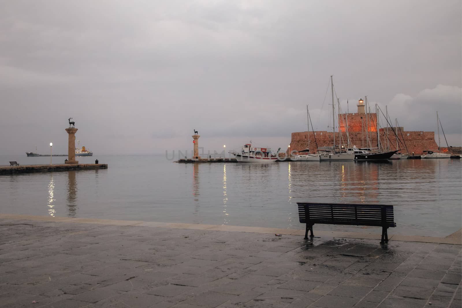 Yachts and the three old mills of the old harbor of Rhodes, Greece