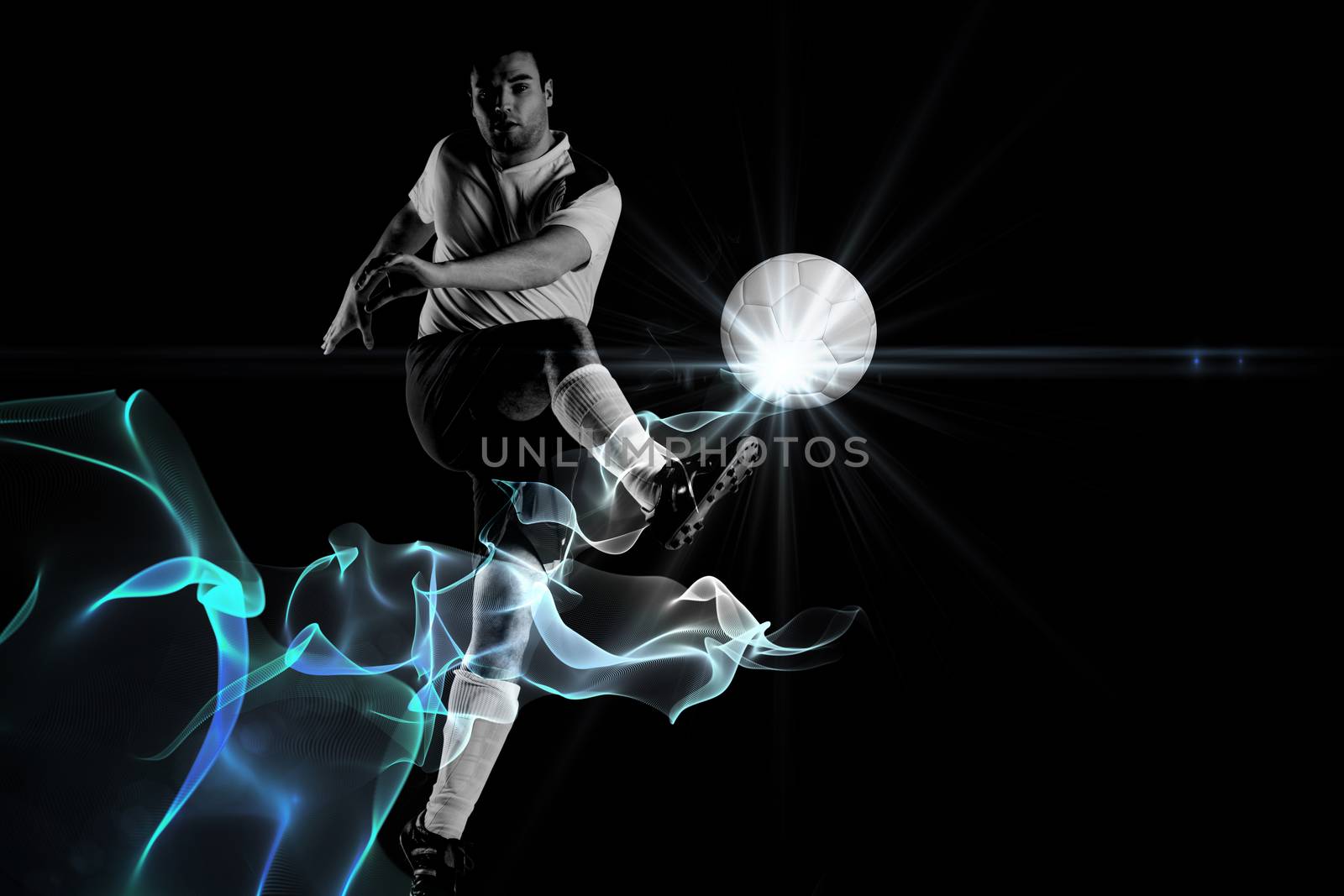 Football player in white kicking against abstract glowing black background