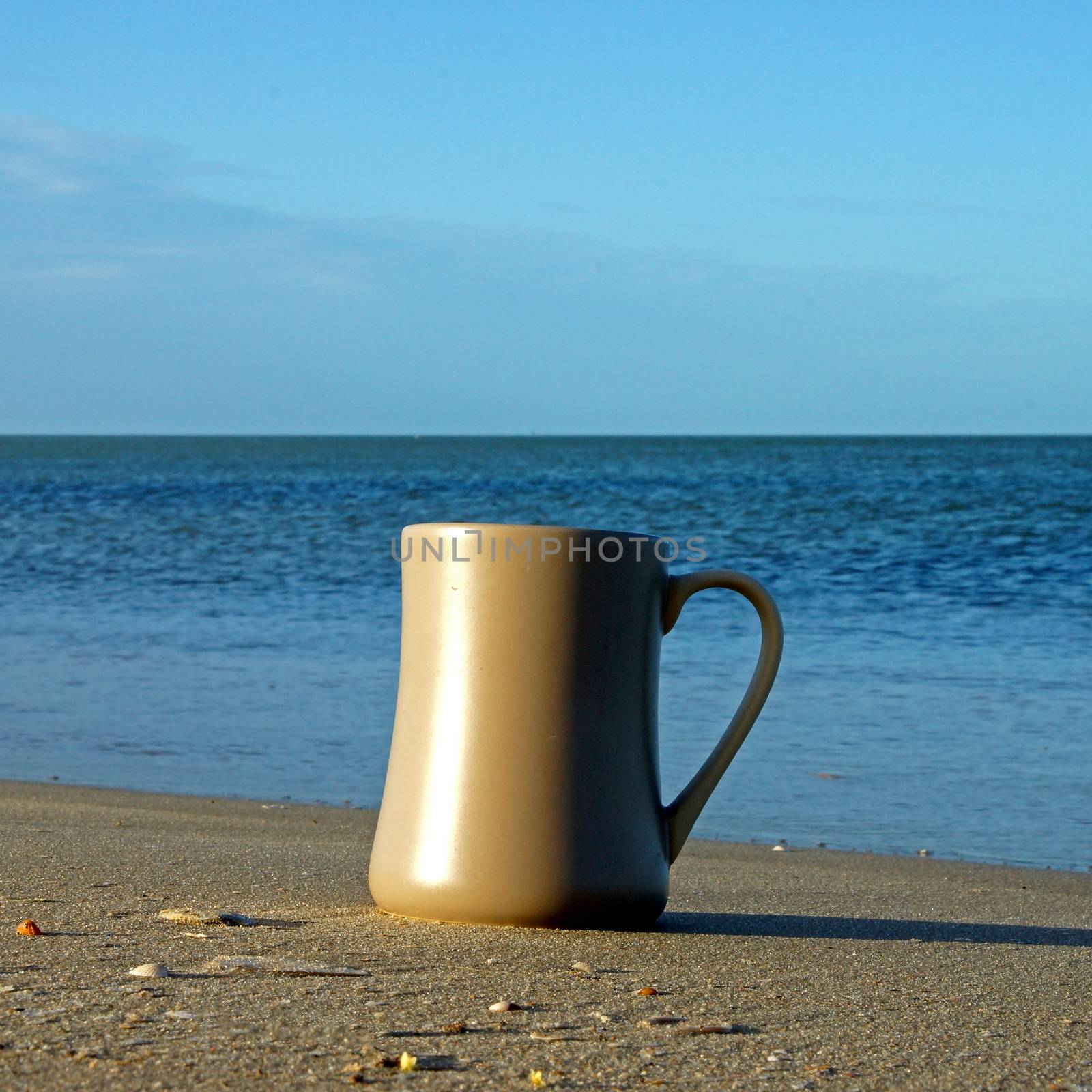 Coffee at the beach in the morning light and sunrise.