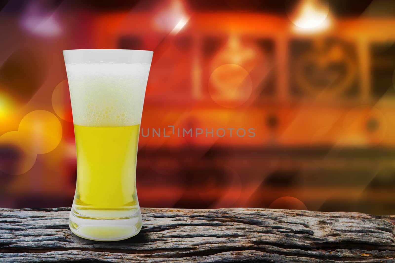 Beer is placed on a wooden table in the pub for tourists at night