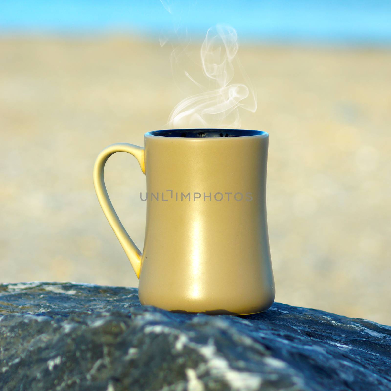 Coffee at the beach in the morning light and sunrise.