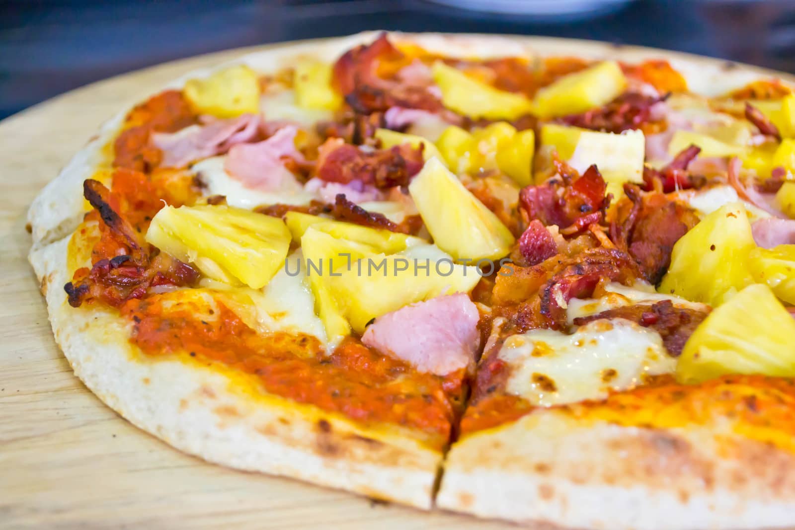 Pizza lifted slice garnish with pineapple by Thanamat