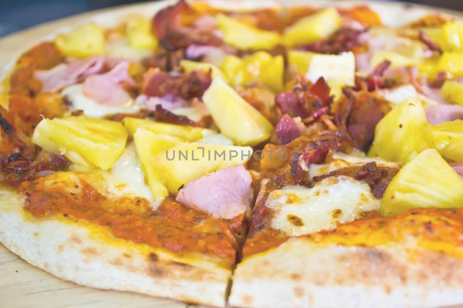 Pizza lifted slice garnish with pineapple