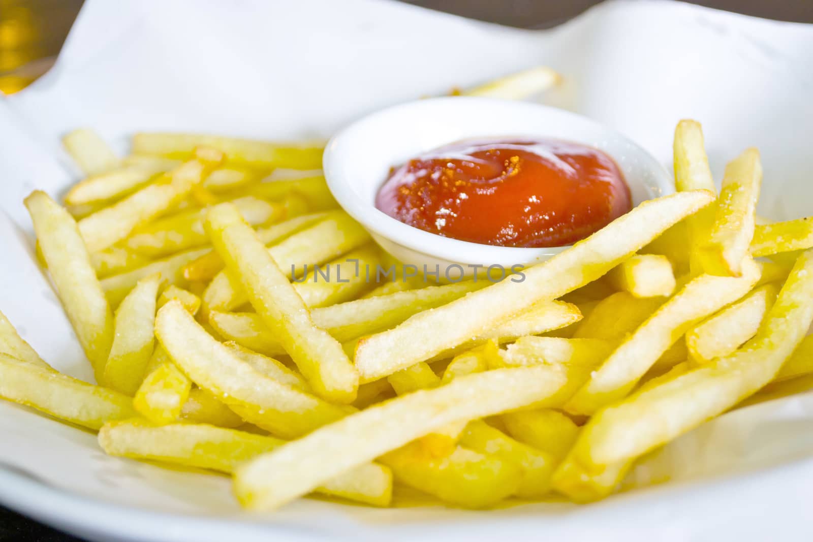 French fries and ketchup on the plate by Thanamat