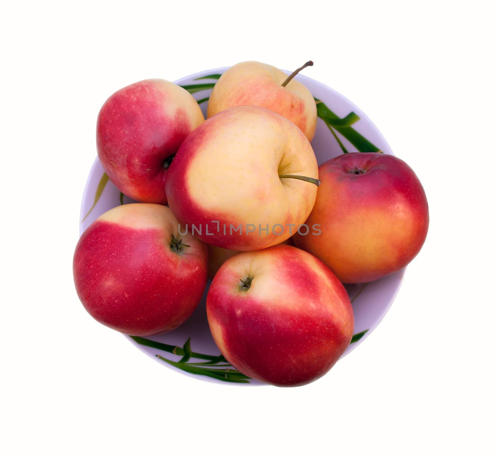 Red-yellow apples on a plate isolated on white background