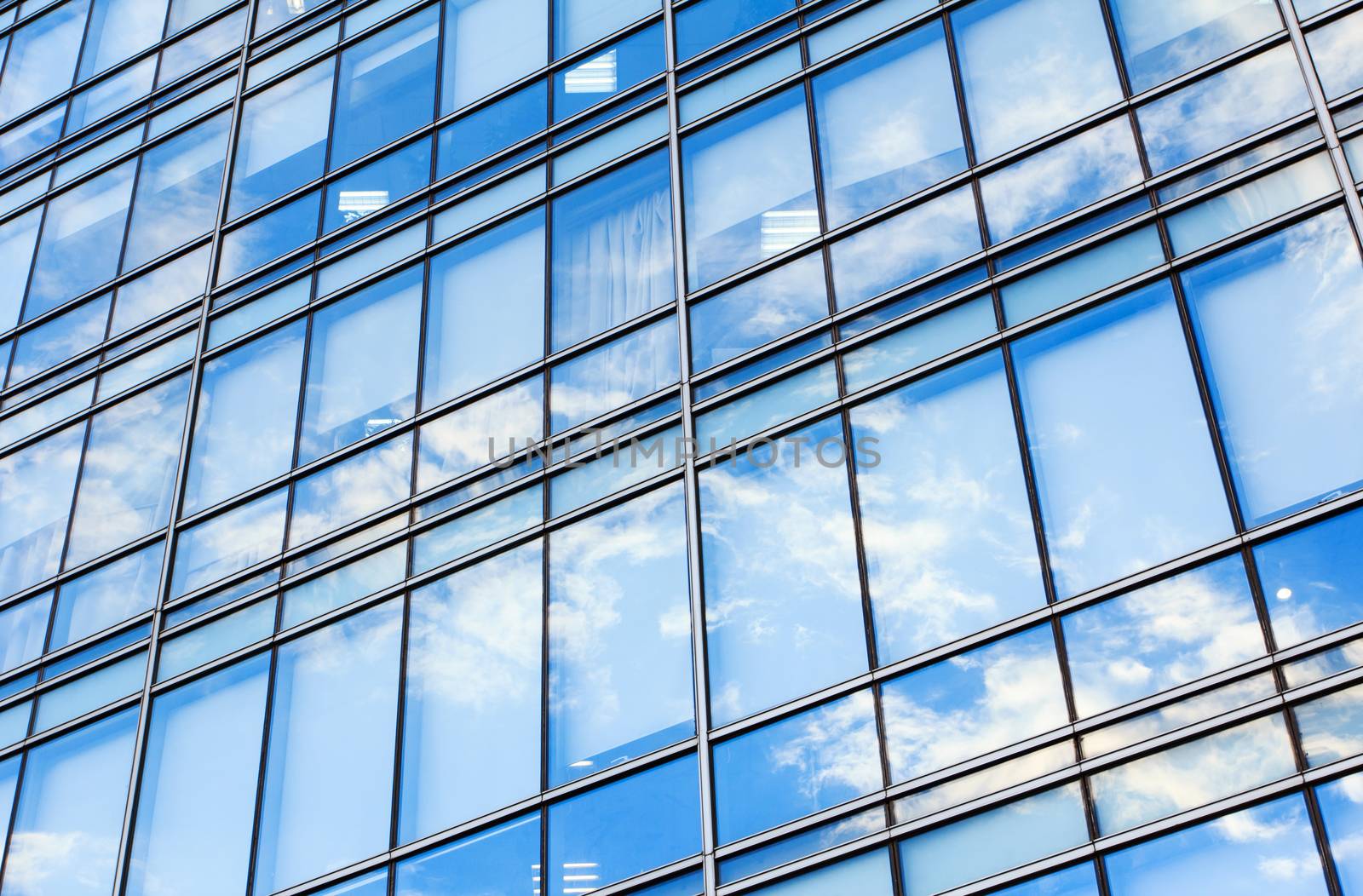 glass wall of office building,with reflection of clouds