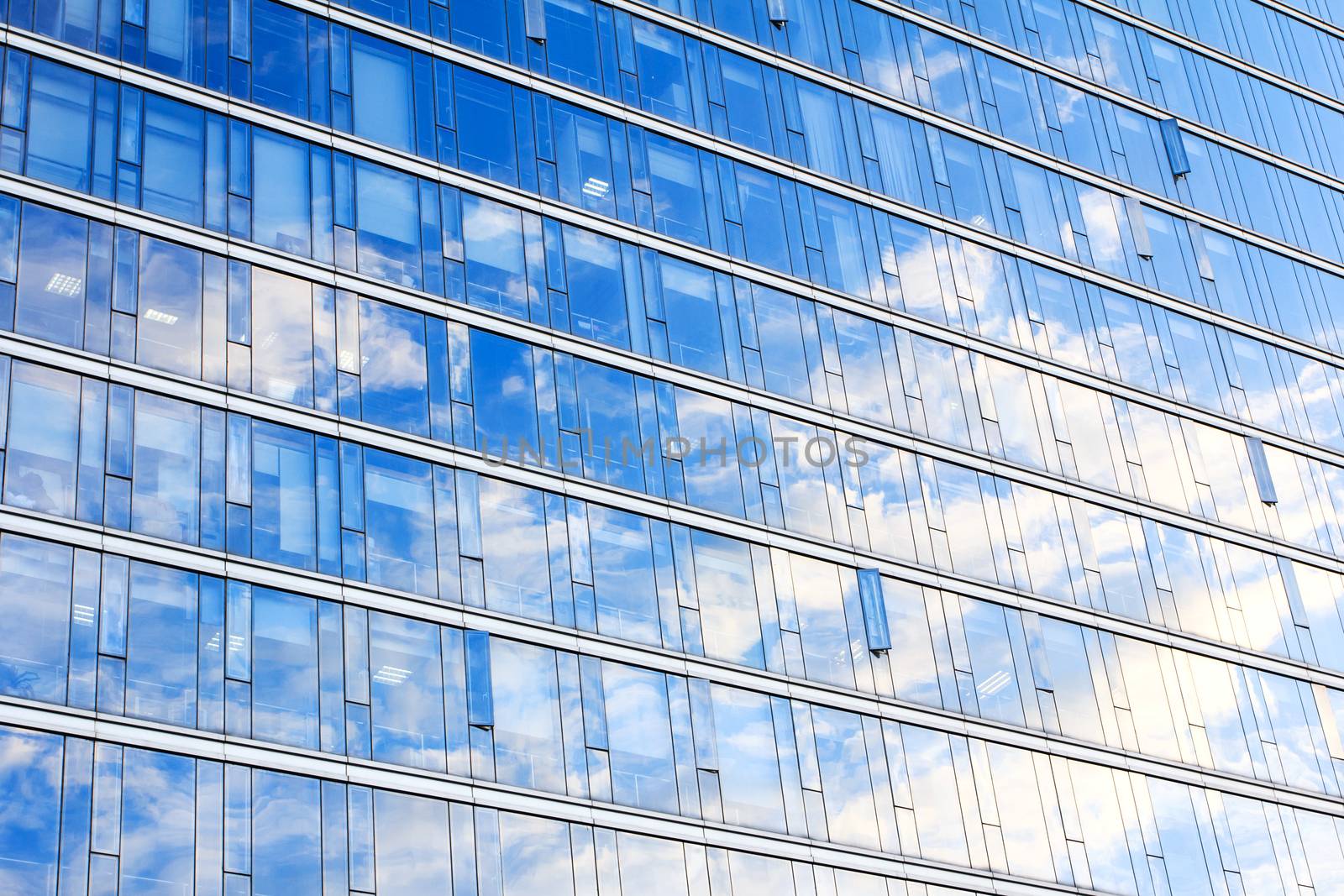 glass wall of office building,with reflection of clouds