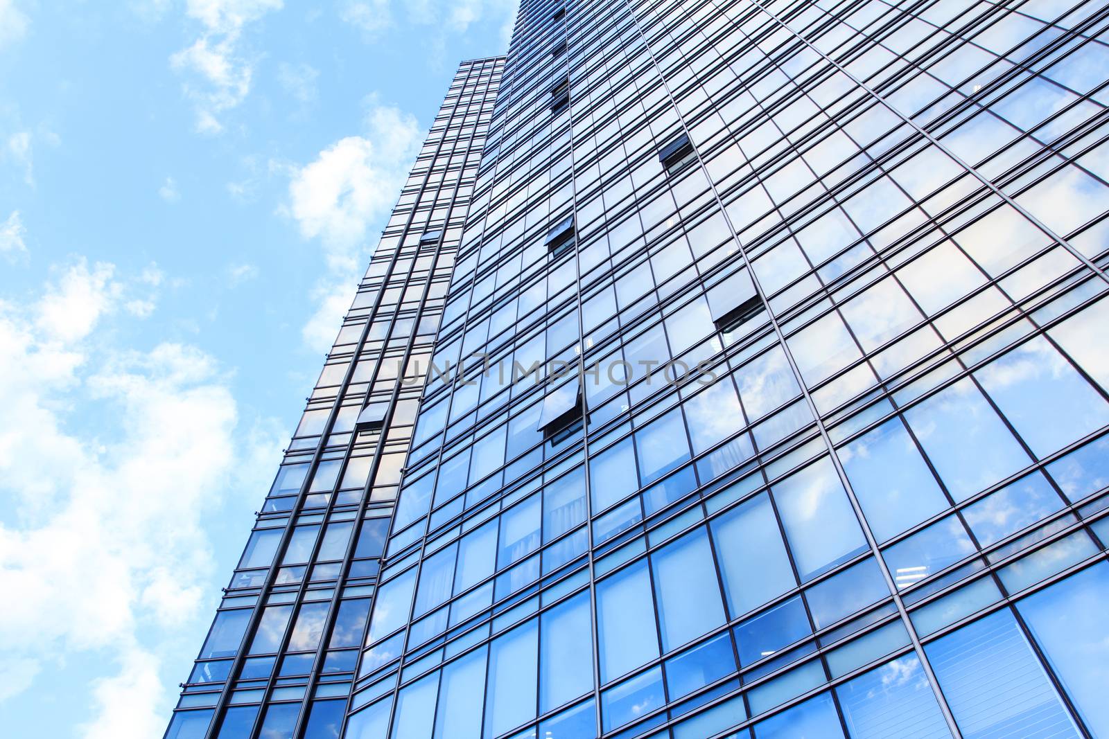 glass wall of office building,with reflection of clouds